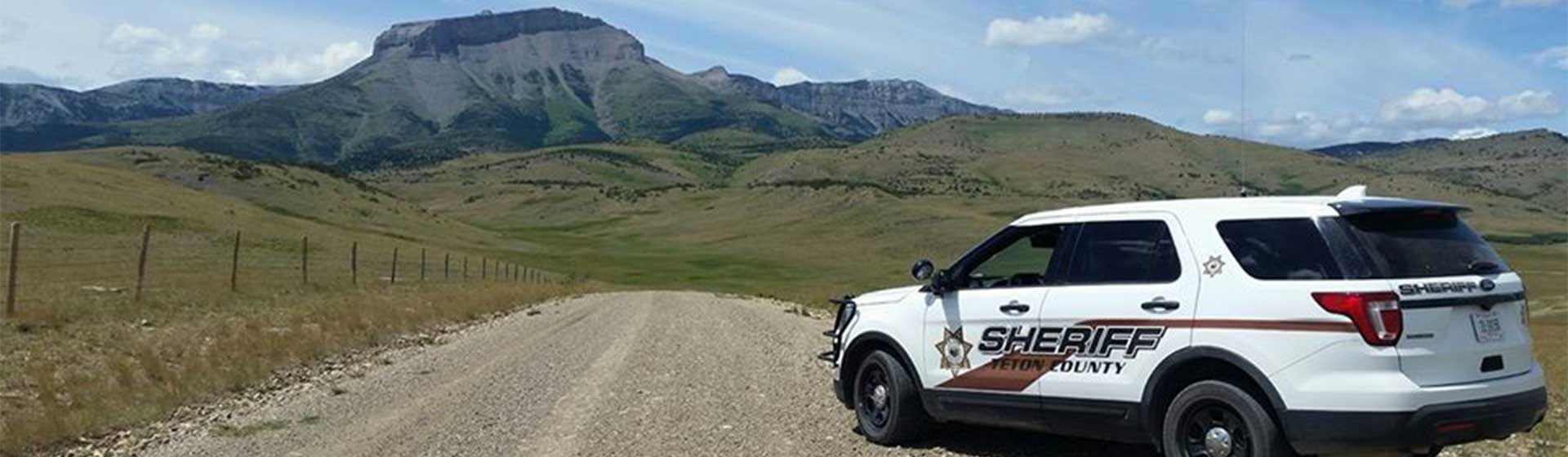 Sheriff vehicle with mountain range in the distance